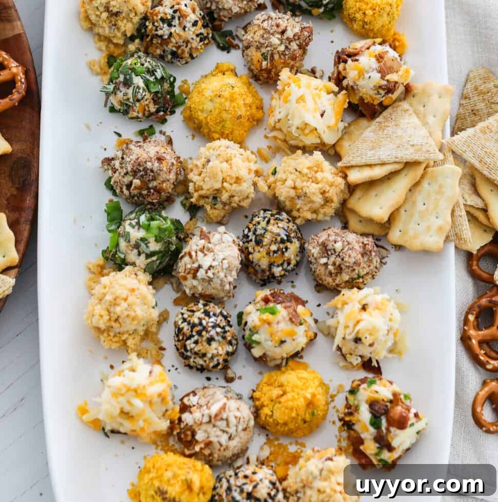 Savory Mini Cheese Truffles: Bite-Sized Party Cheese Balls 21 A white platter filled with cheese truffles with crackers and pretzels