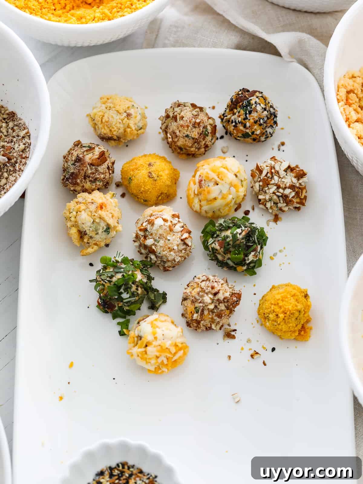 Savory Mini Cheese Truffles: Bite-Sized Party Cheese Balls 9 Making cheese truffles on a platter