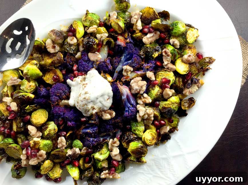 Crispy Roasted Brussels Sprouts with Pomegranate Molasses Glaze 4 roasted brussels sprouts on white plate with serving spoon