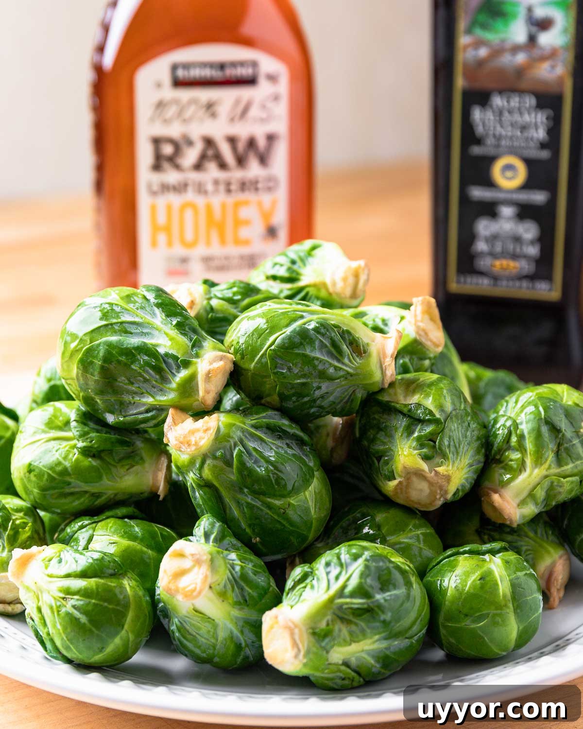 Ingredients shown: honey, balsamic vinegar, and plate of brussels sprouts.