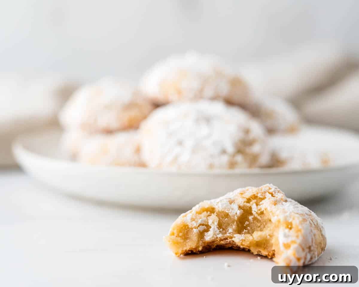 Chewy Ricciarelli: Traditional Italian Almond Cookies 9 Taking a bite of the chewy Italian almond cookie.