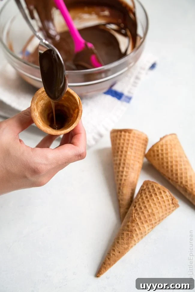 line inside of sugar cones with melted chocolate.
