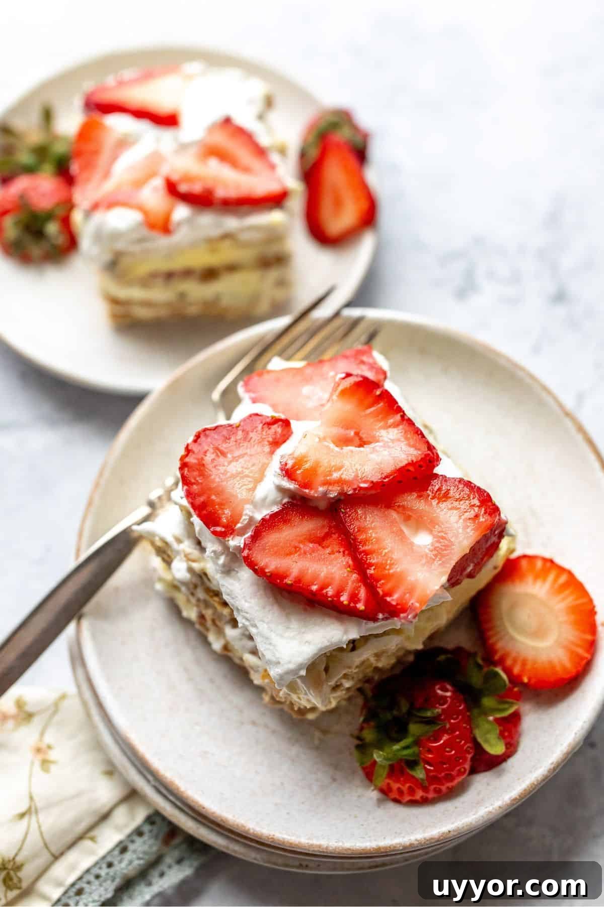 Strawberry Icebox Cake on a white plate with a silver fork.