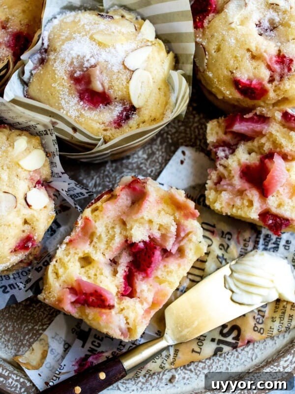 Muffins on a plate with butter and strawberries.