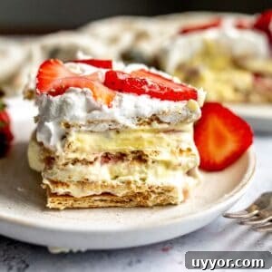 Strawberry Icebox Cake on several white plates with a silver fork.