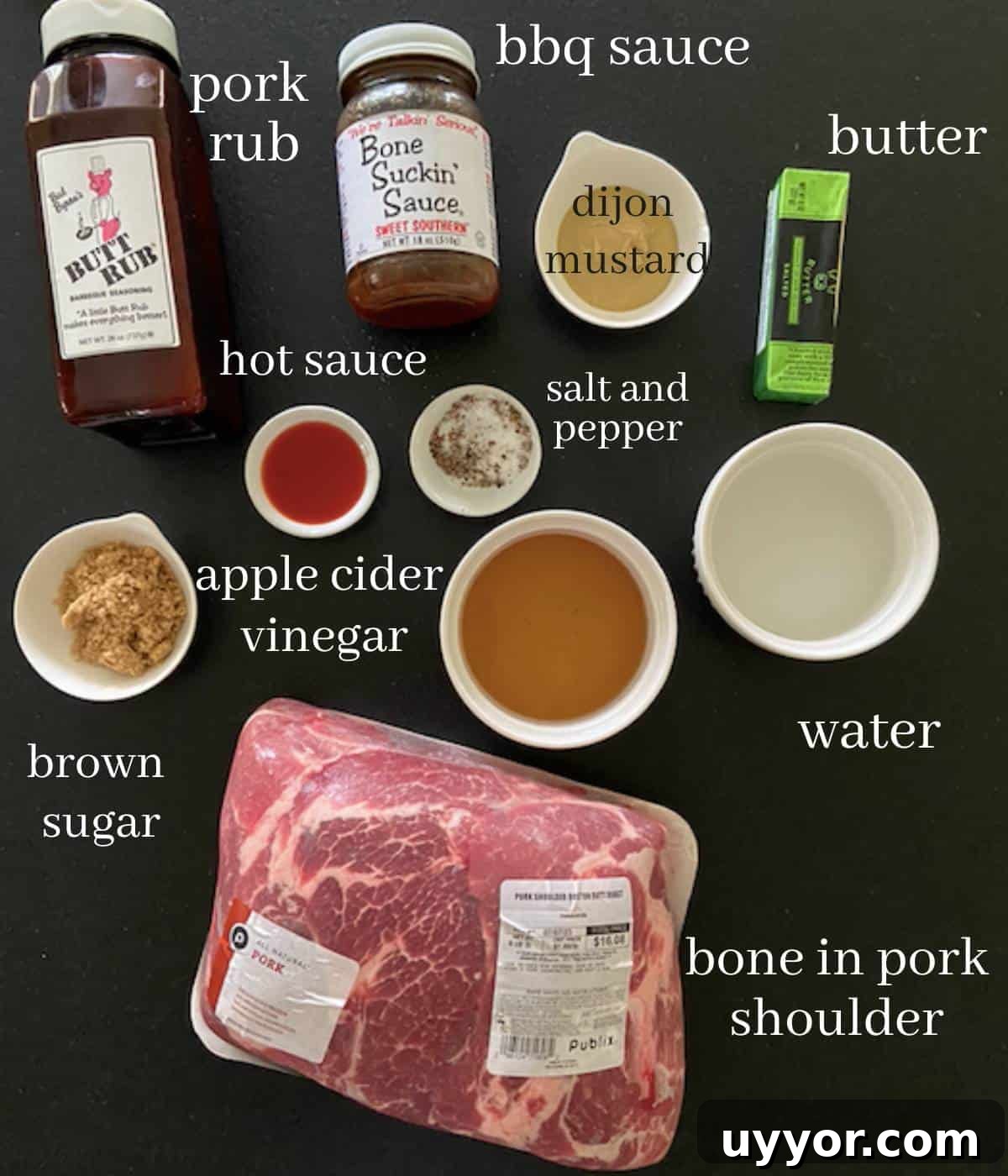 How to Smoke a Pork Butt for Tender, Flavorful Pulled Pork 3 Smoked pork shoulder ingredients on black countertop.