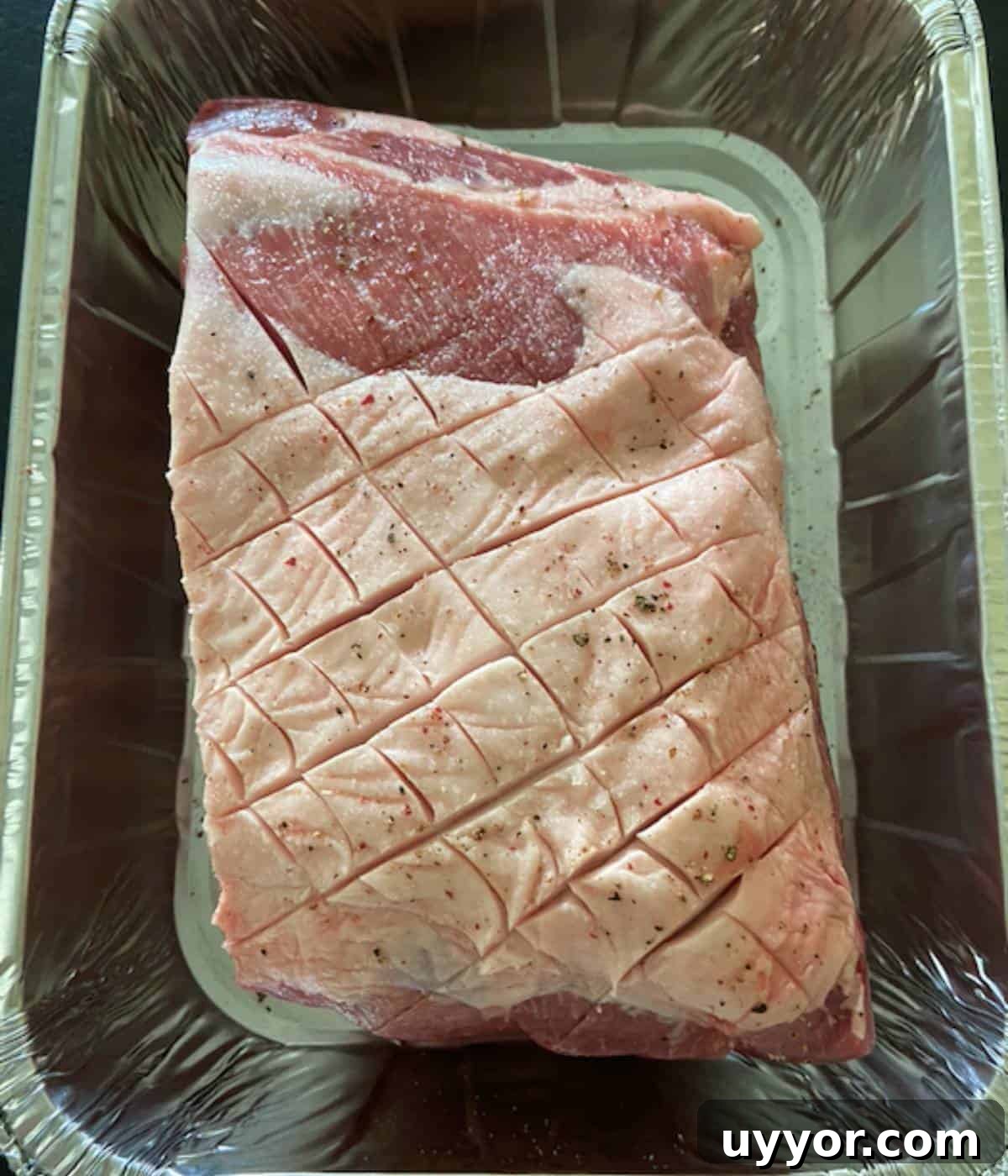 How to Smoke a Pork Butt for Tender, Flavorful Pulled Pork 5 Scored pork butt in tin foil pan.