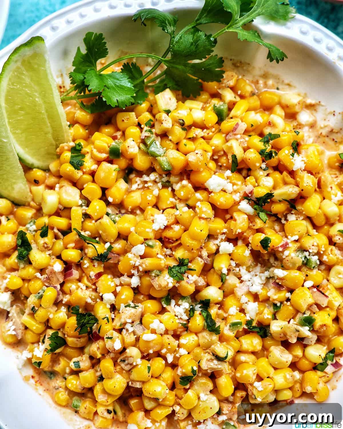Creamy Mexican Street Corn Dip (Elote Dip) Recipe 2 big bowl of elote dip (Mexican corn dip) with side of lime wedges and cilantro.