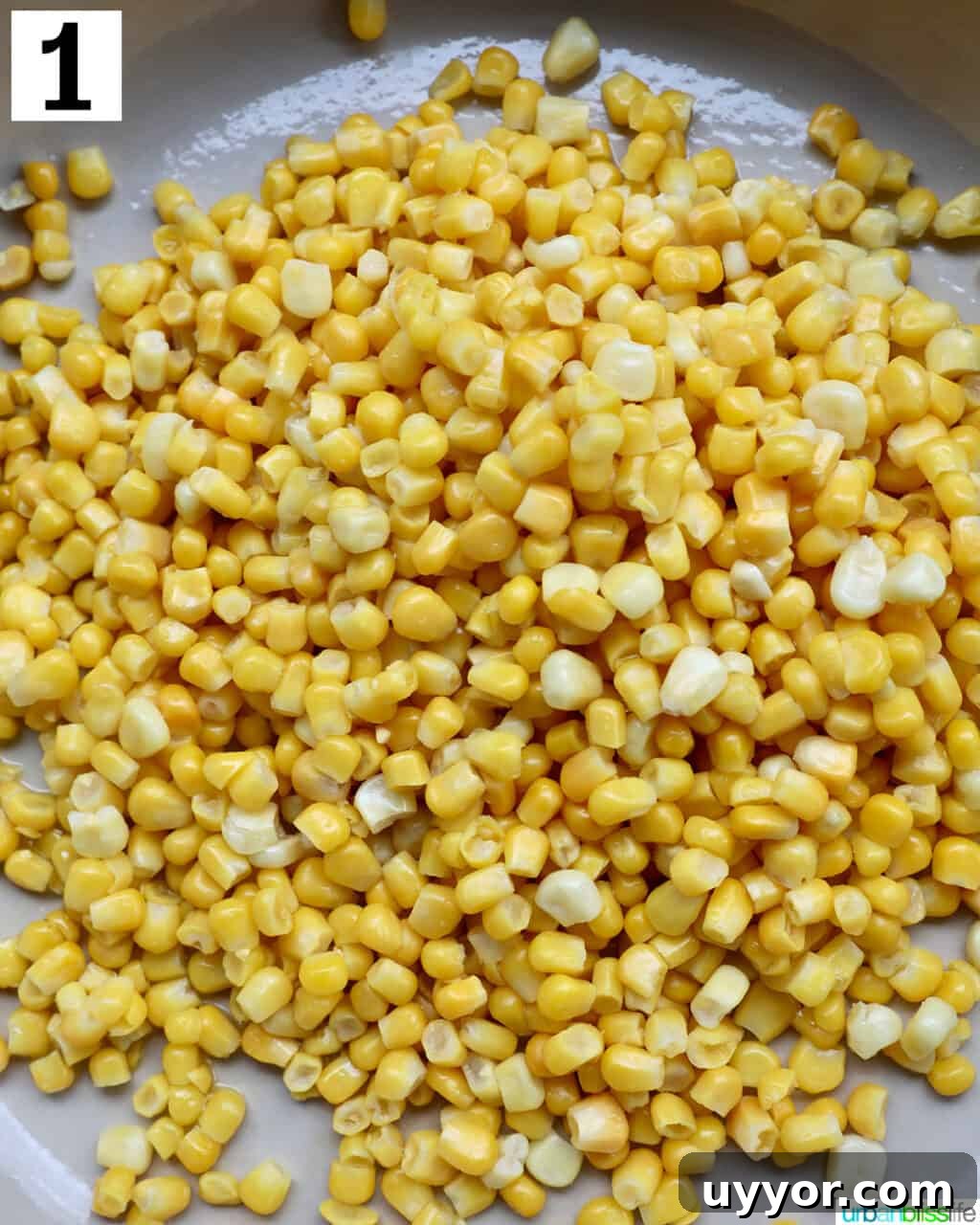 Creamy Mexican Street Corn Dip (Elote Dip) Recipe 5 corn kernels cooking in a large saucepan.