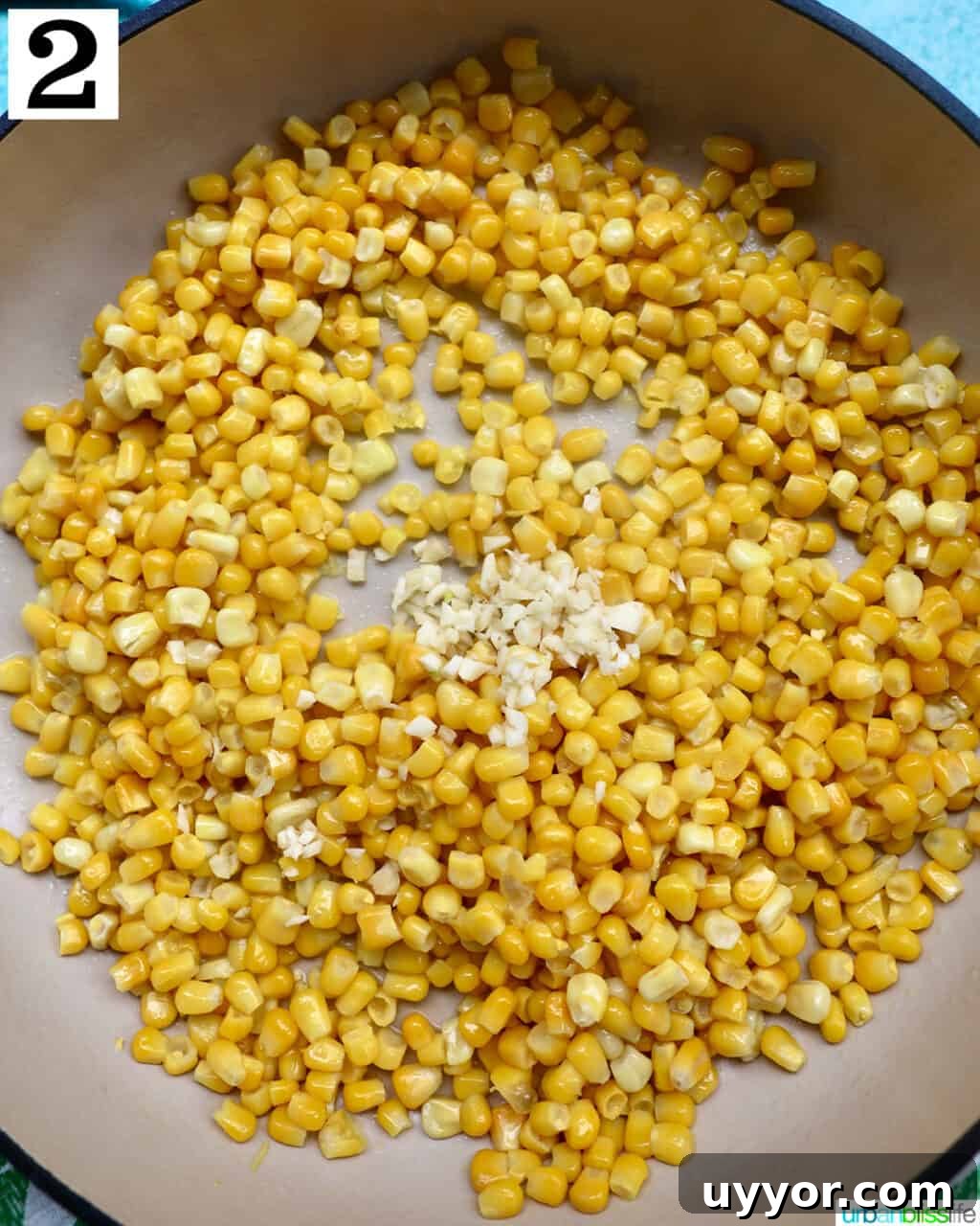 Creamy Mexican Street Corn Dip (Elote Dip) Recipe 6 corn kernels and minced garlic cooking in a large saucepan.