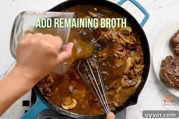 Salisbury Steak with Savory Mushroom and Onion Gravy 8 Pouring in remaining broth to the mushrooms and onions