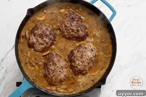 Salisbury Steak with Savory Mushroom and Onion Gravy 9 Cooked patties added to mushroom gravy in the skillet