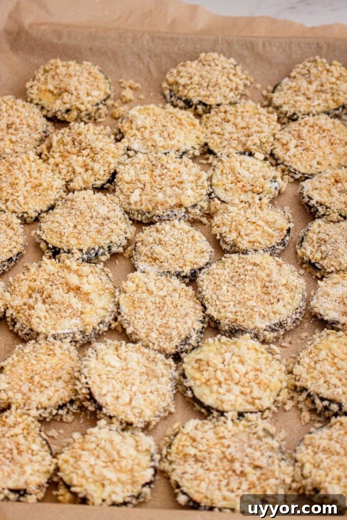 Classic Homemade Eggplant Parmesan Recipe for Crispy Layers 6 Eggplant slices in a baking dish ready for the oven.