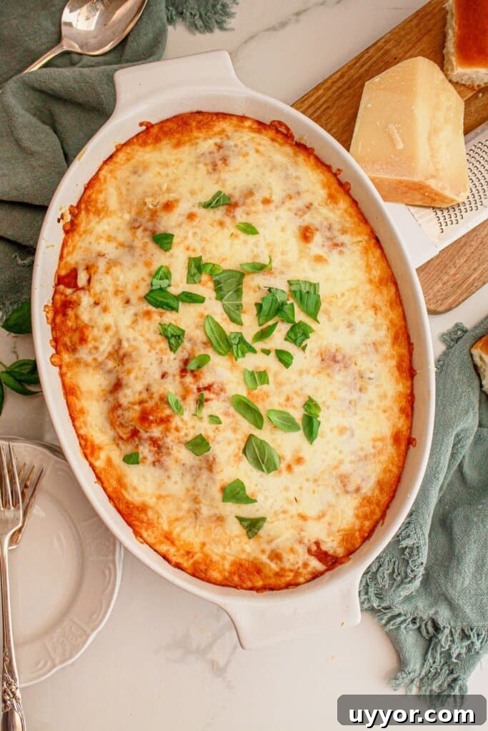 Classic Homemade Eggplant Parmesan Recipe for Crispy Layers 10 Eggplant parmesan in an oval baking dish on a counter.
